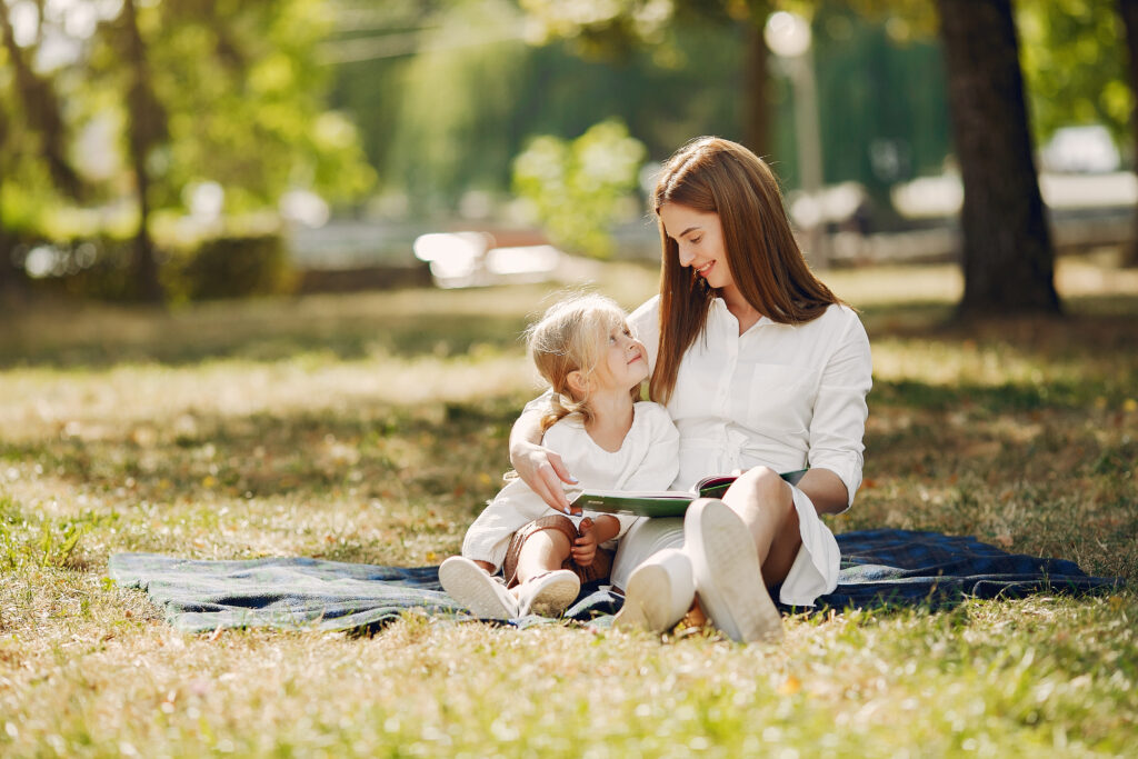 A parent and child reading a book together at home